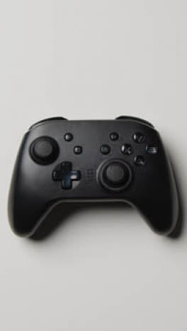 Vertical-Video-Overhead-Studio-Hand-Reaching-In-Picking-Up-Video-Game-Controller